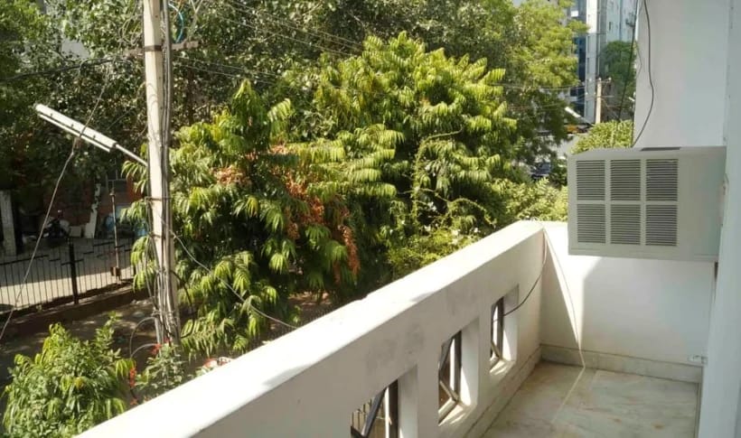 Balcony view onto leafy street